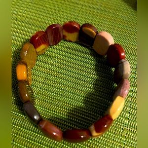 Muted tone multicolor bracelet. I have medium wrists.  It fits well